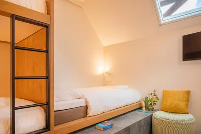 a bedroom with a bunk bed and a mirror at Bunk Hotel Amsterdam in Amsterdam