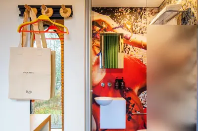 a door to a kitchen with a painting on the wall at Bunk Hotel Utrecht in Utrecht