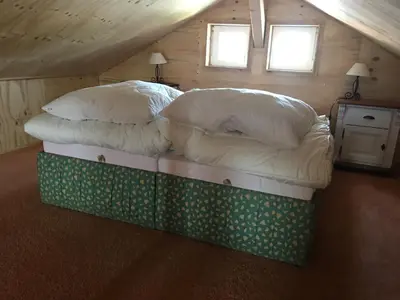 a bed in a room with two pillows on it at Einzigartiges Haus am Isselmeer in Wervershoof