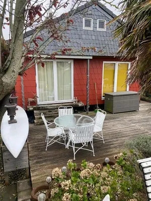 a patio with a table and chairs and a house at Einzigartiges Haus am Isselmeer in Wervershoof