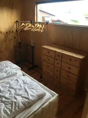 a bedroom with a bed and a dresser and a window at Einzigartiges Haus am Isselmeer in Wervershoof
