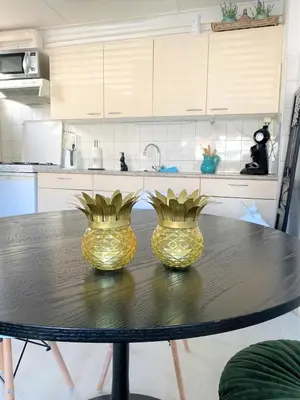 two yellow vases sitting on a table in a kitchen at De Kneet in Egmond aan Zee