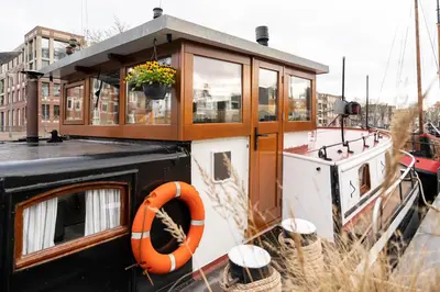 a small boat with an orange life ring on it at B&B Vita Nova in Amersfoort