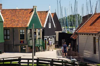 a group of houses with people walking down a street at EuroParcs Markermeer in Bovenkarspel