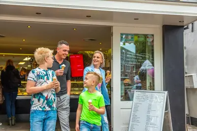 a group of people standing outside of a store at EuroParcs Markermeer in Bovenkarspel