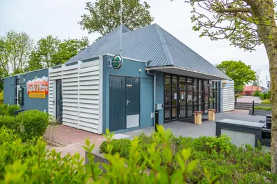 a building with a blue and white facade at EuroParcs Markermeer in Bovenkarspel