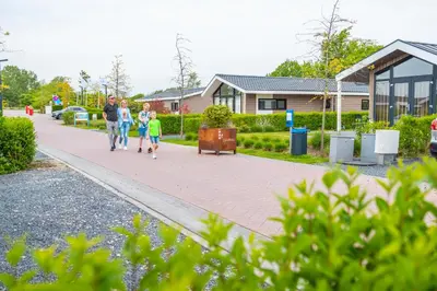 a group of people walking down a sidewalk at EuroParcs Markermeer in Bovenkarspel