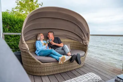 a man and a woman sitting in a chair on a boat at EuroParcs Markermeer in Bovenkarspel