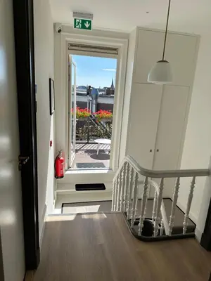 a stairway leading to a door with a balcony at Boutique hotel Margretha in Zandvoort