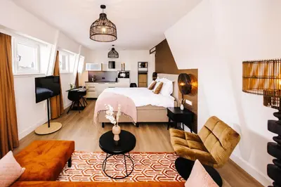 a bedroom with a bed and a living room at Boutique hotel Margretha in Zandvoort