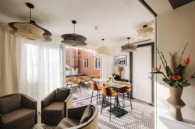 a living room with a table and chairs at Boutique hotel Margretha in Zandvoort