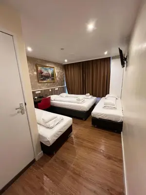 a hotel room with two beds in a room at Dam Hotel in Amsterdam