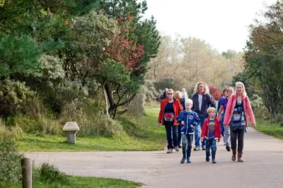 a group of people walking down a path at Apartment Seastar Zandvoort in Zandvoort