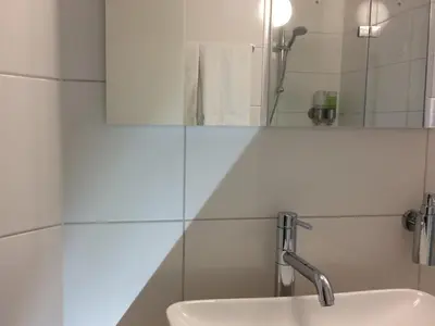 a bathroom with a sink and a mirror at Haarlem 49 in Haarlem