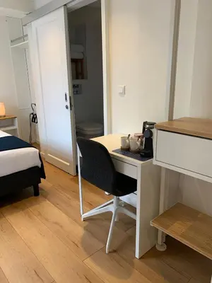 a room with a desk and a bed and a bedroom at PH93 Amsterdam Central in Amsterdam