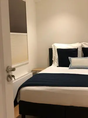 a bedroom with a bed with a blue and white blanket at PH93 Amsterdam Central in Amsterdam