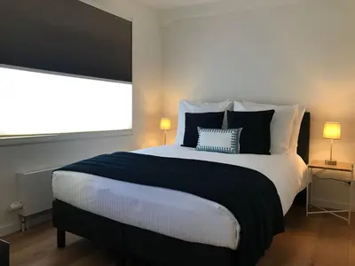 a bedroom with a large bed with two lamps at PH93 Amsterdam Central in Amsterdam