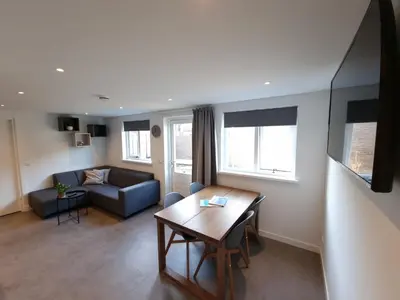 a living room with a couch and a table at Zomerhuis de Jong in Egmond aan Zee