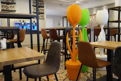 a restaurant with tables and chairs and balloons at Landgoed ISVW in Leusden