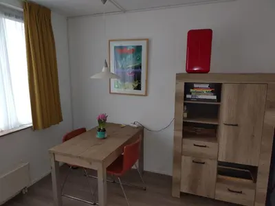 a room with a desk and a table with chairs at Quiet spacious room in Amsterdam