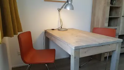 a desk with two chairs and a lamp on it at Quiet spacious room in Amsterdam