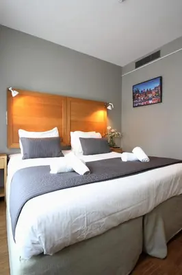 a large bed in a hotel room with two pillows at The Bank Hotel in Amsterdam