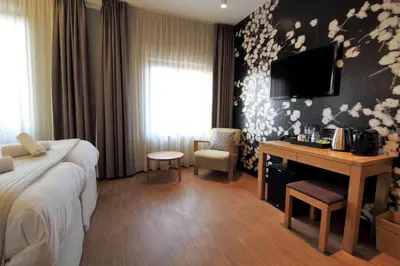 a hotel room with a bed and a desk at The Bank Hotel in Amsterdam