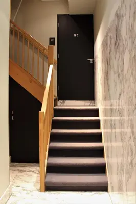 a set of stairs with a door in a building at The Bank Hotel in Amsterdam