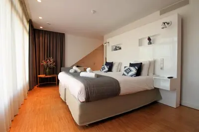 a bedroom with a large bed in a room at The Bank Hotel in Amsterdam