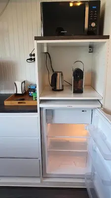 a refrigerator with its door open with a microwave at Guesthouse Zandvoort in Zandvoort
