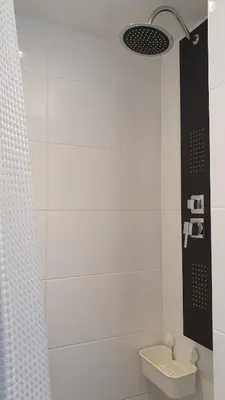 a white bathroom with a toilet and a light at Guesthouse Zandvoort in Zandvoort