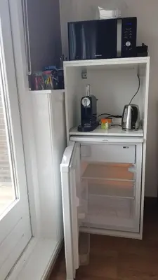 a small kitchen with a microwave and a coffee maker at Guesthouse Zandvoort in Zandvoort