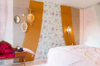 a bedroom with a bed and a wall with flowers at Hotel The Exchange in Amsterdam