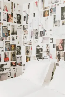 a wall covered in photos of people at Hotel The Exchange in Amsterdam