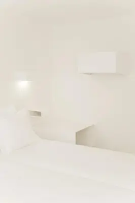 a white room with a white floor and a lamp at Hotel The Exchange in Amsterdam