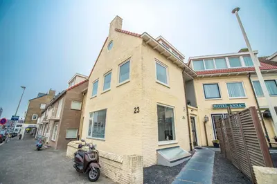 a house with a scooter parked in front of it at Bad Zandvoort in Zandvoort