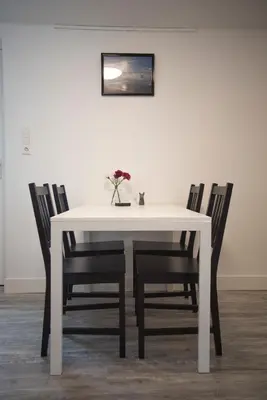 a white dining room table with four chairs at Bad Zandvoort in Zandvoort