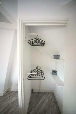 a room with white walls and stairs with metal shelves at Bad Zandvoort in Zandvoort