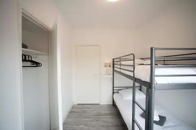 a room with two bunk beds and a hallway at Bad Zandvoort in Zandvoort