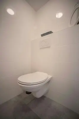 a bathroom with a white toilet in a room at Bad Zandvoort in Zandvoort