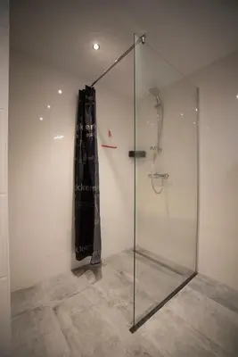 a shower with a glass door in a room at Bad Zandvoort in Zandvoort