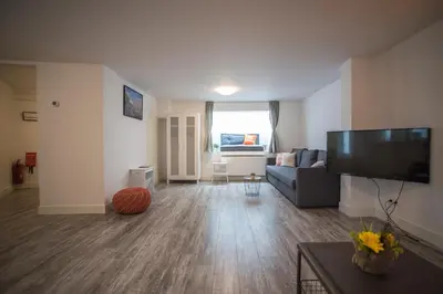 a living room with a couch and a flat screen tv at Bad Zandvoort in Zandvoort