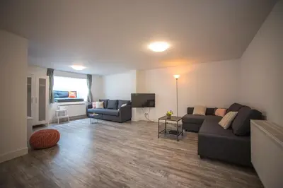 a living room with a couch and a tv at Bad Zandvoort in Zandvoort