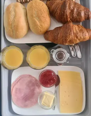 a lunch box filled with bread and different types of condiments at Mi BnB Amsterdam in Amsterdam