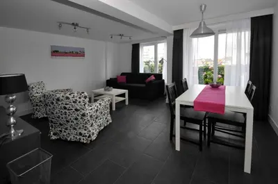 a living room with a table and a dining room at Schelvis Apartments in Zandvoort