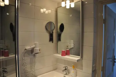 a bathroom with a sink and a mirror at Schelvis Apartments in Zandvoort