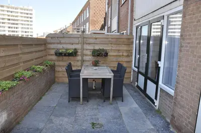 a small patio with a table and chairs on a building at Schelvis Apartments in Zandvoort