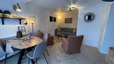 a living room with a table and a couch at Schelvis Apartments in Zandvoort