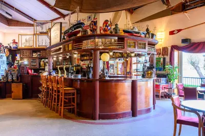 a bar in a restaurant with tables and chairs at De Rijper Eilanden in De Rijp