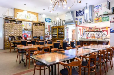 a restaurant with tables and chairs in a room at De Rijper Eilanden in De Rijp